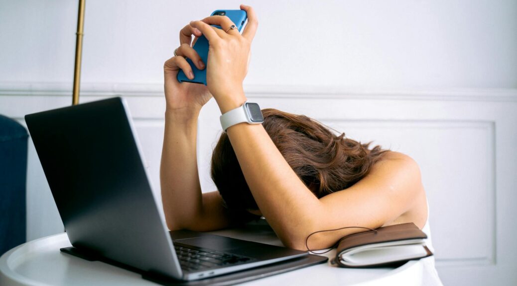 a woman wearing a smartwatch holding a smartphone