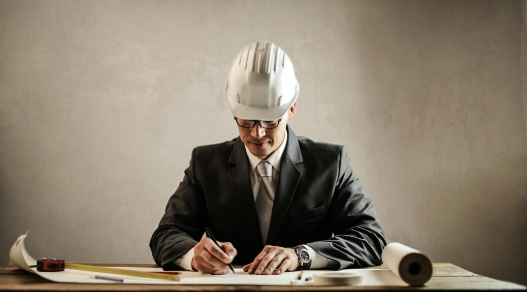 professional architect working with draft in office